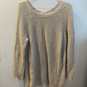 Oversized tan sweater with braided detail in the back.